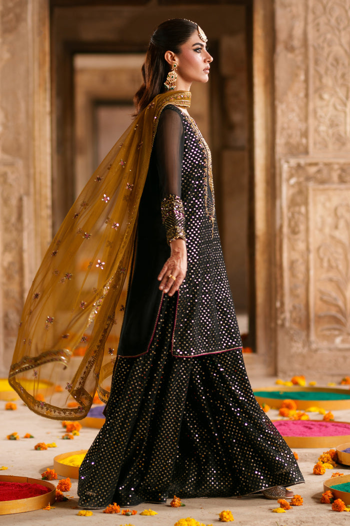 Side view of Irra black crinkle semi formal outfit featuring brown contrast net dupatta and embellished flary pants