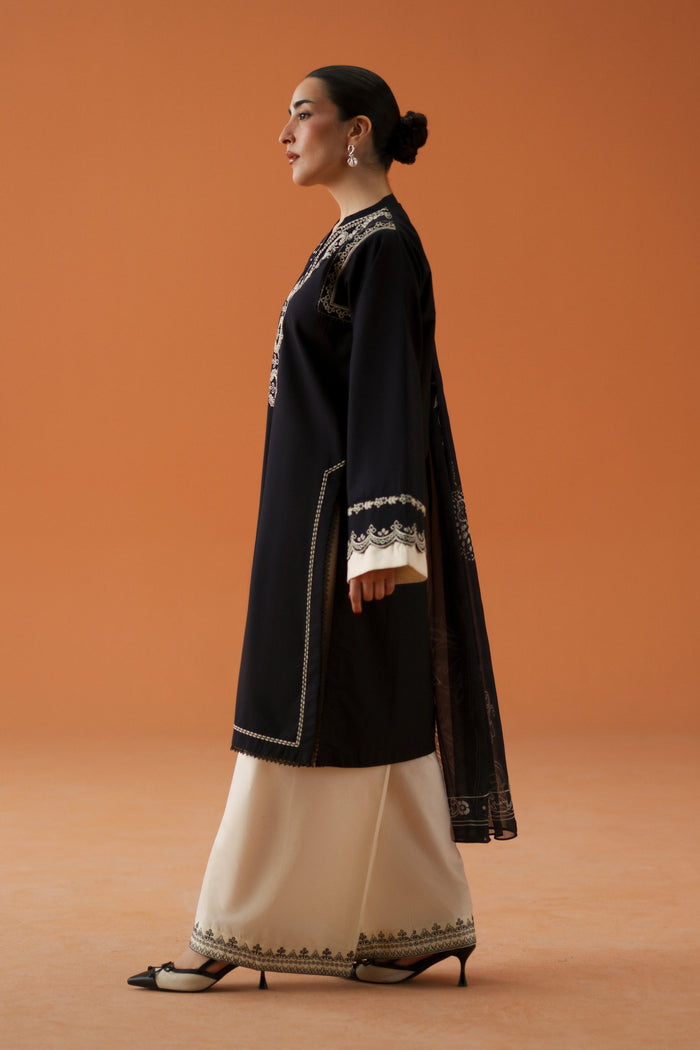 Side view of Isla black ready-to-wear dress showing long lawn shirt, embroidered sleeves, culotte trousers, and soft chiffon dupatta.
