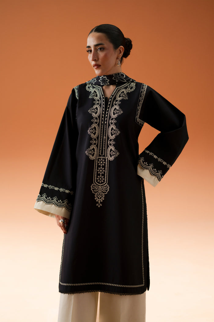 Front pose of Isla black semi-formal outfit showing detailed embroidery, long straight shirt, and wide cambric culotte trousers.