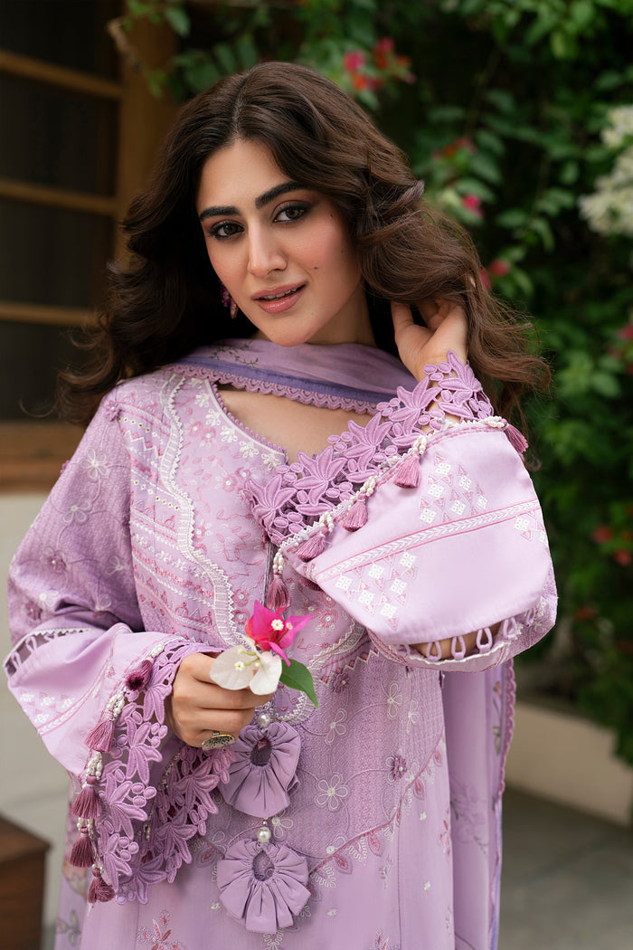 Close-up portrait of Izna lilac embroidered outfit highlighting tassel neckline, schiffli motifs and floral printed dupatta styling