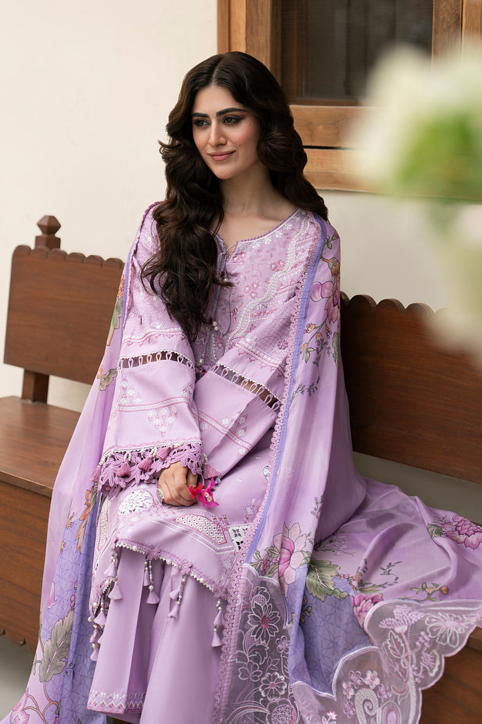 Seated styling shot of NAQSHI Izna lilac summer outfit featuring embroidered lawn shirt, cambric culottes and elegant floral dupatta