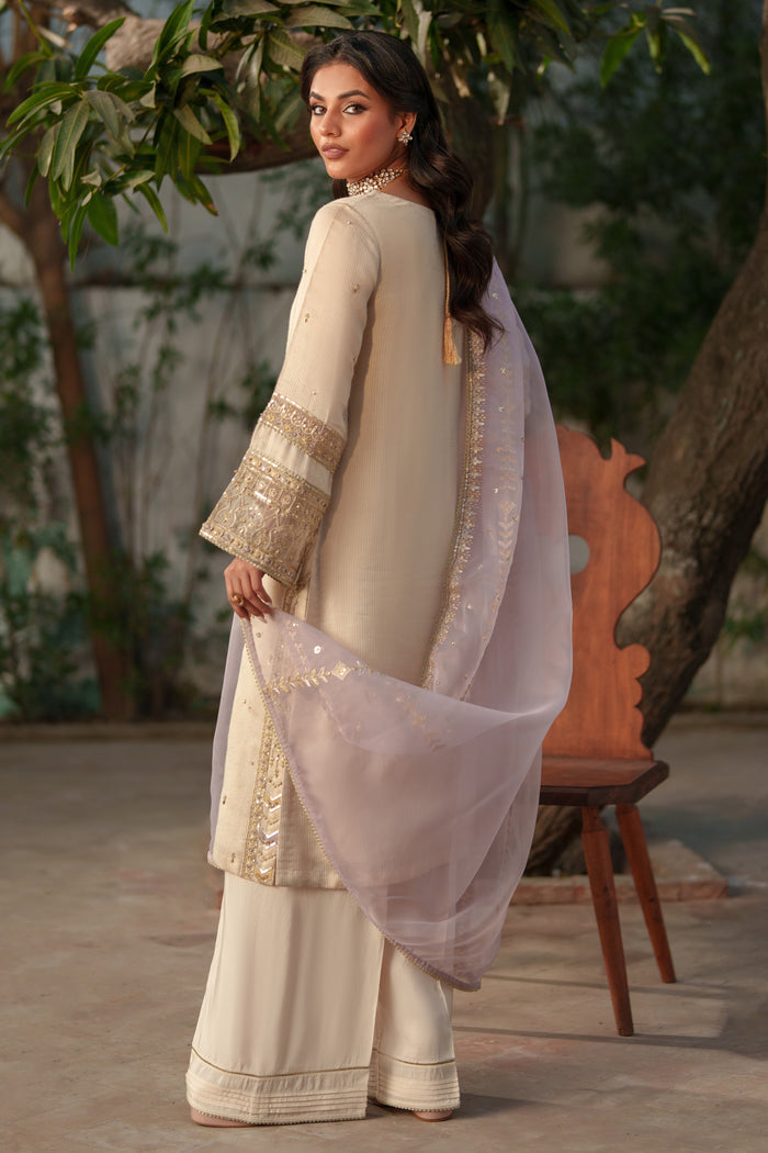 NAQSHI Kai side profile: straight‑cut viscose shirt paired with raw silk culottes silhouette