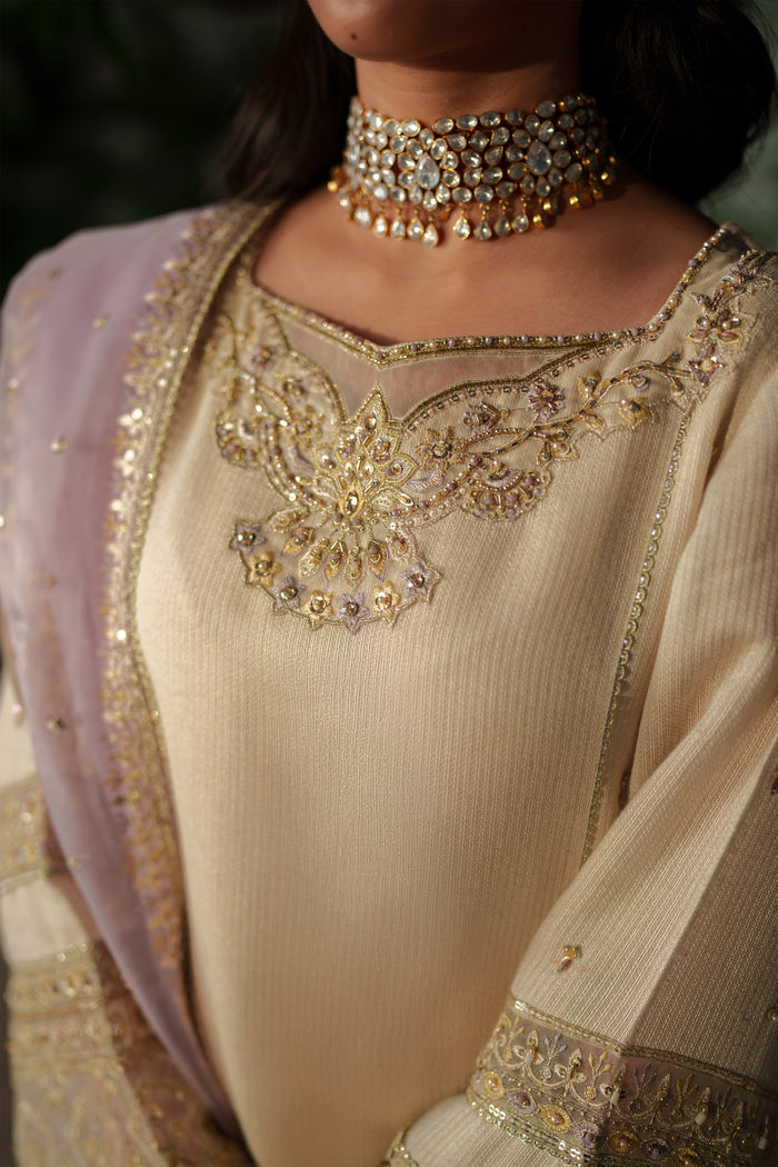 NAQSHI Kai close‑up of adda embroidery and thread embroidery on shirt sleeve cuff.