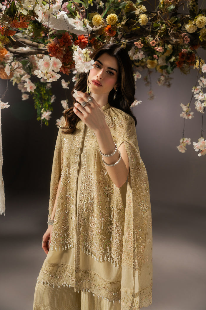 Livia pale yellow evening outfit in side view, showing the flowing embroidered Organza cape and slit sleeve detailing.