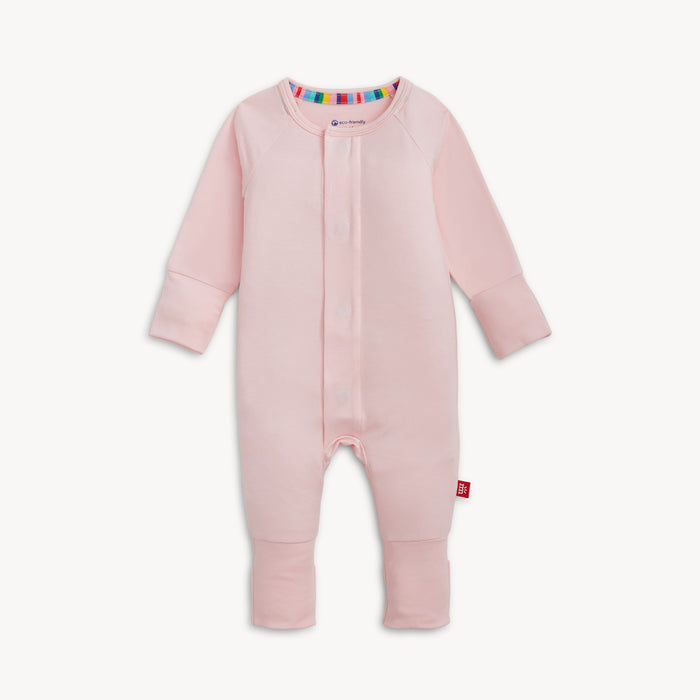 A solid light pink long-sleeve convertible coverall romper with a hidden magnetic closure by Magnetic Me.
