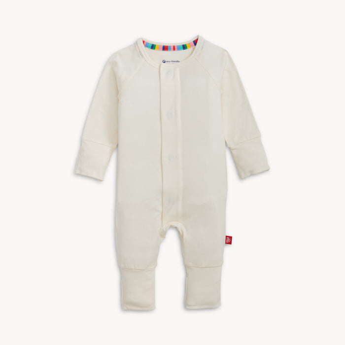 A solid off white long-sleeve convertible coverall romper with a hidden magnetic closure by Magnetic Me.