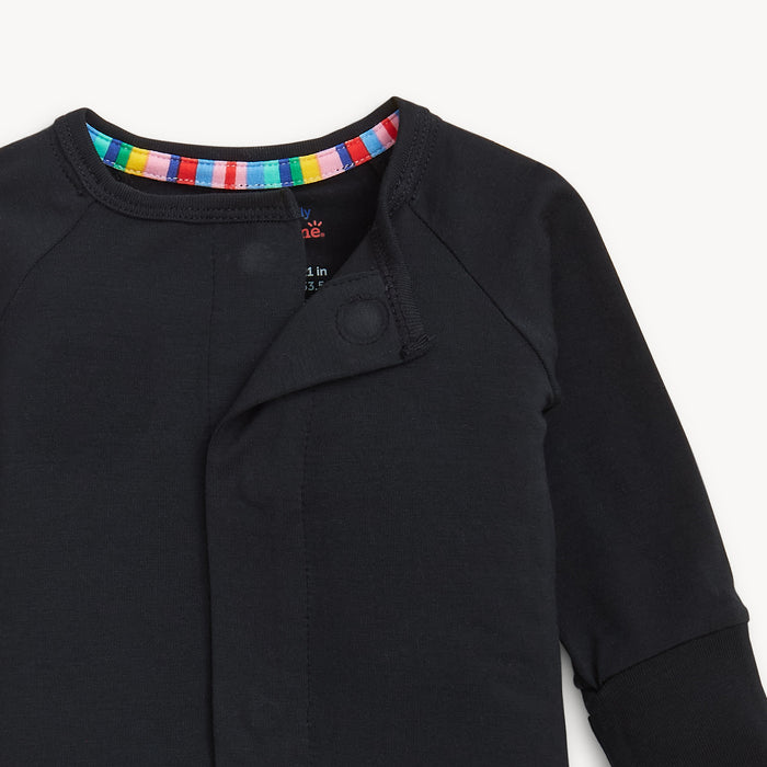 Open magnet in the center of A solid black long-sleeve convertible coverall romper with a hidden magnetic closure by Magnetic Me.