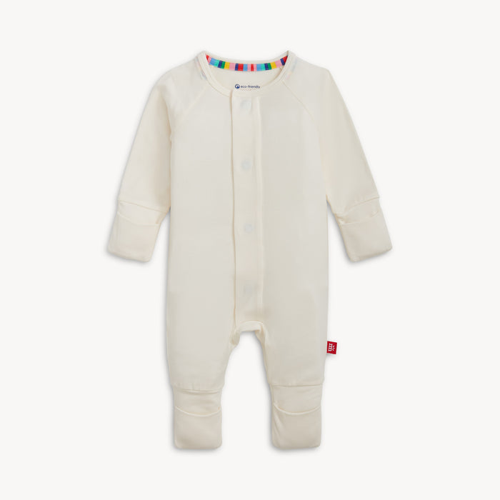 A solid off white long-sleeve convertible coverall romper with a hidden magnetic closure by Magnetic Me.