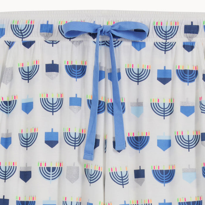 matching joggers, both detailed with an all-over print of blue and silver dreidels and menorahs, by Magnetic Me.
