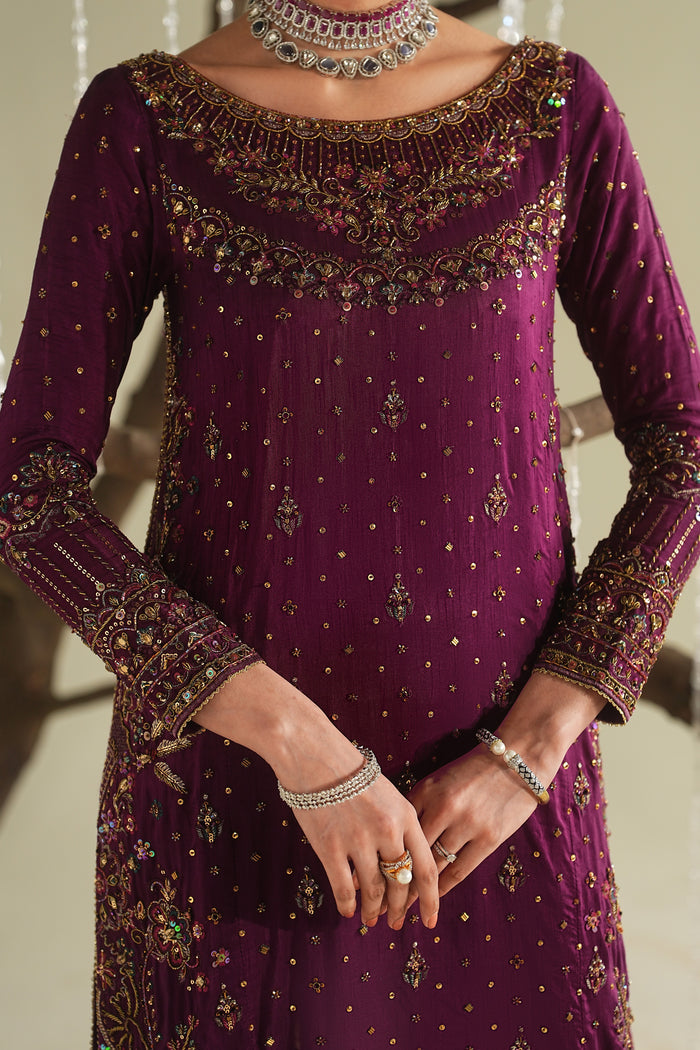 Close-up of deep plum formal shirt showing detailed embroidery on neckline and sleeves with fine fabric finish