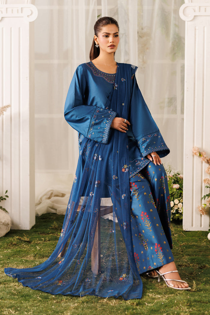Seated pose of NAQSHI Mihha outfit showing flowing net dupatta, lace details, and easy casual styling