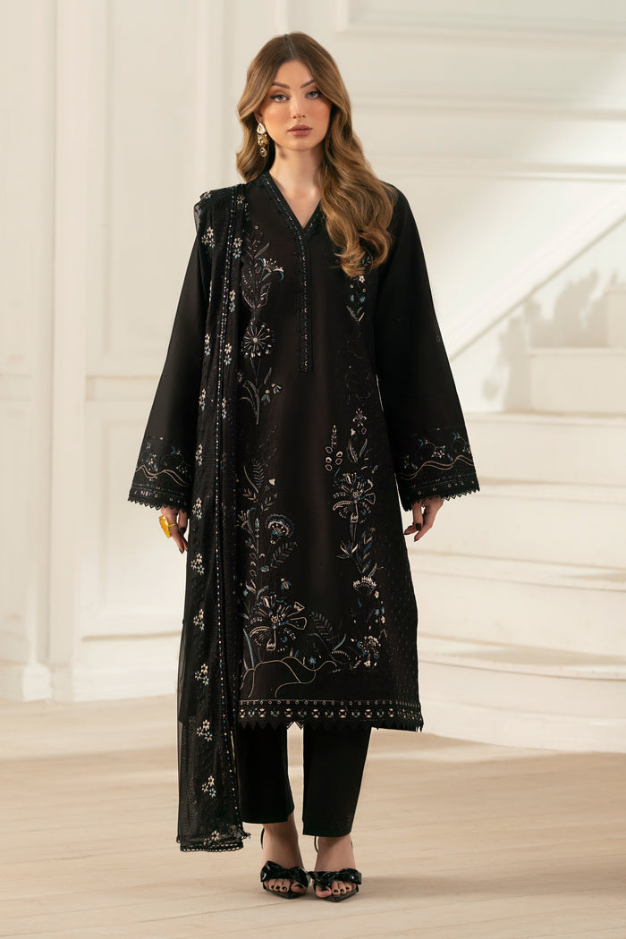 NAQSHI Moheeni front: straight‑cut black cambric shirt adorned with heavy embroidered borders, beaded neck pati, lace‑trim hem and straight pants