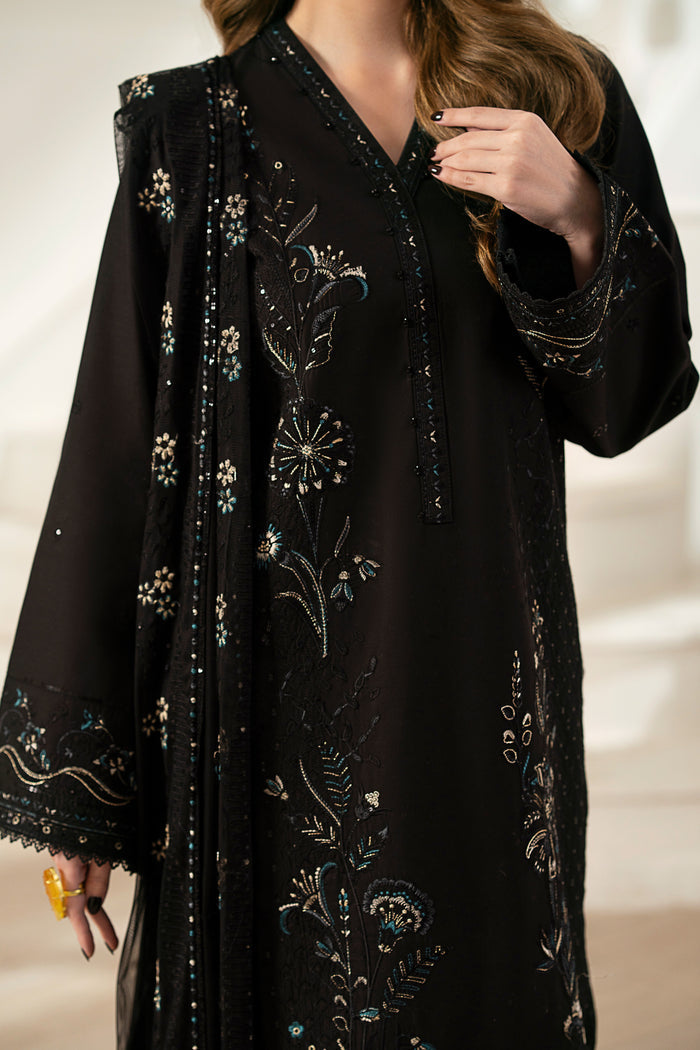 Model wearing full NAQSHI Moheeni 3PC: heavily embroidered black cambric shirt, straight pants & ornate net dupatta—showing complete look