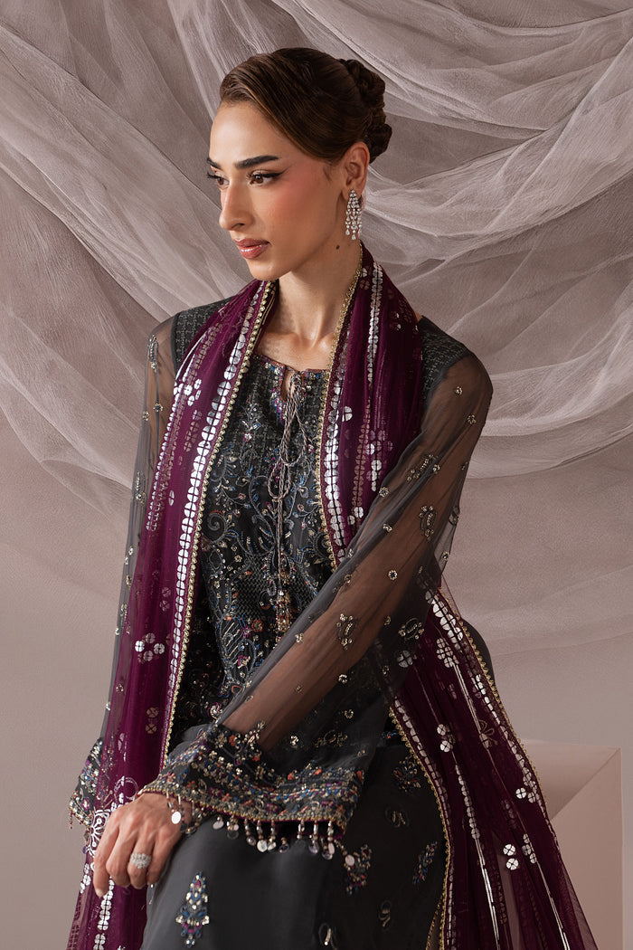 Seated three-quarter view of Moriah dark grey semi-formal outfit showing the embroidered shirt and draped contrast Net dupatta.