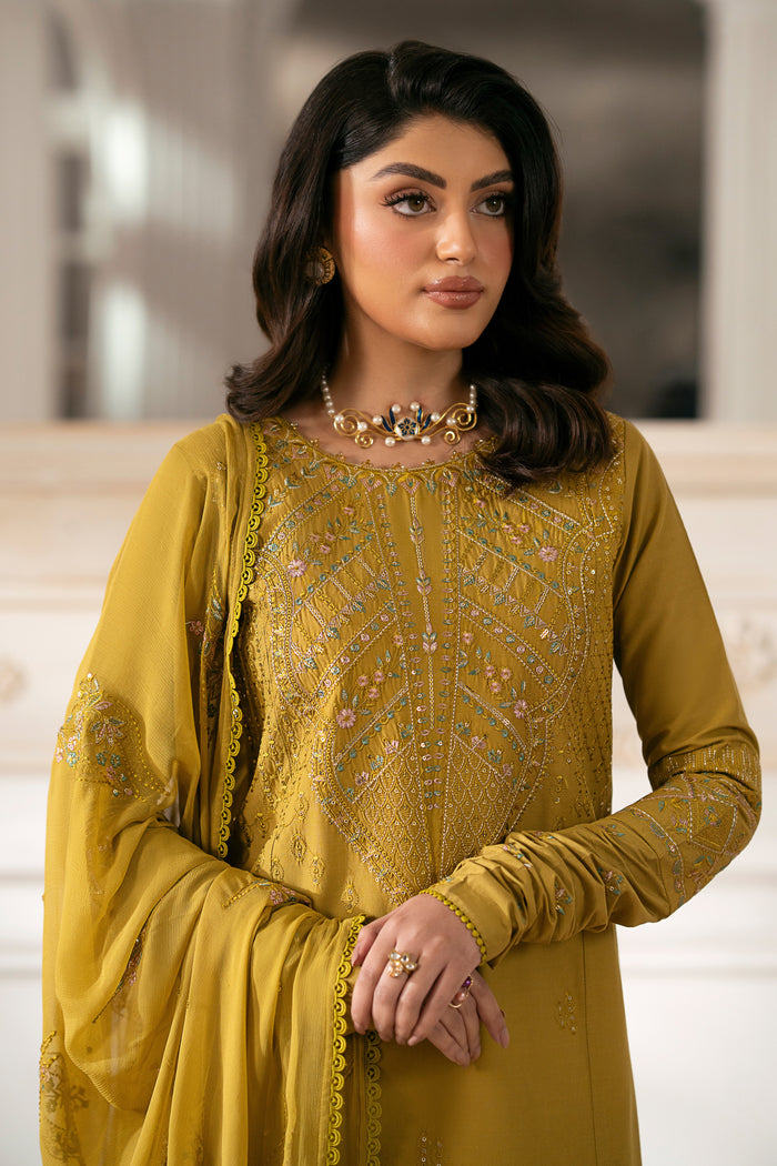 NAQSHI Nageena mustard cambric shirt featuring heavy embroidered round neckline with floral motif, lace-finish hem, straight pants visible