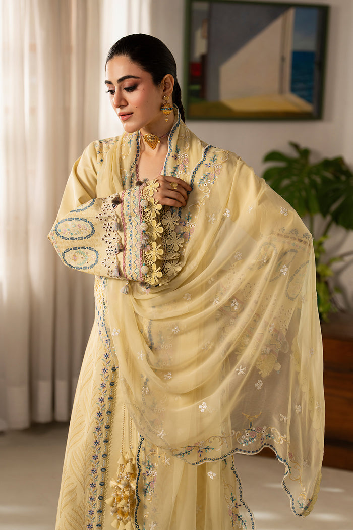 Front styling shot of Nashiman light yellow embroidered lawn dress featuring cambric culottes, decorative embroidery and festive daytime wear look