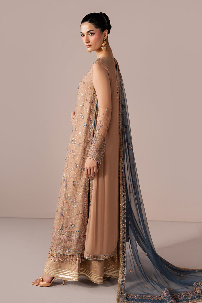 Side view of Navira showing the peach Crinkle shirt, flowing silhouette and contrast embroidered Net dupatta.