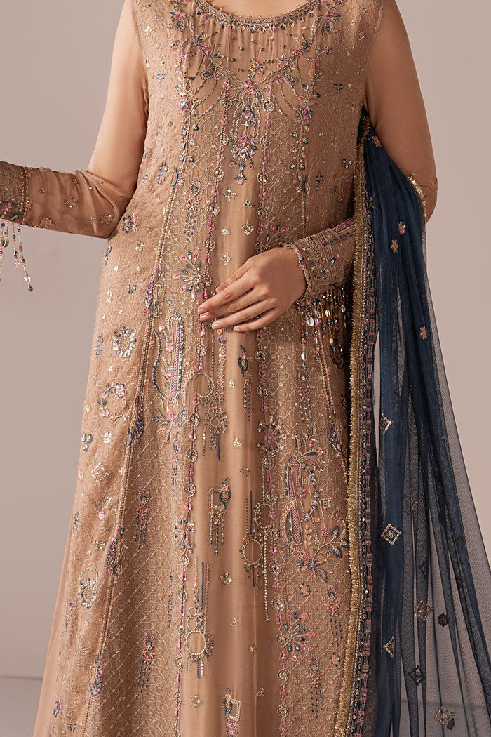 Close-up of Navira showing embroidery, sequins, trim detailing and the contrast dupatta border on the peach shirt.