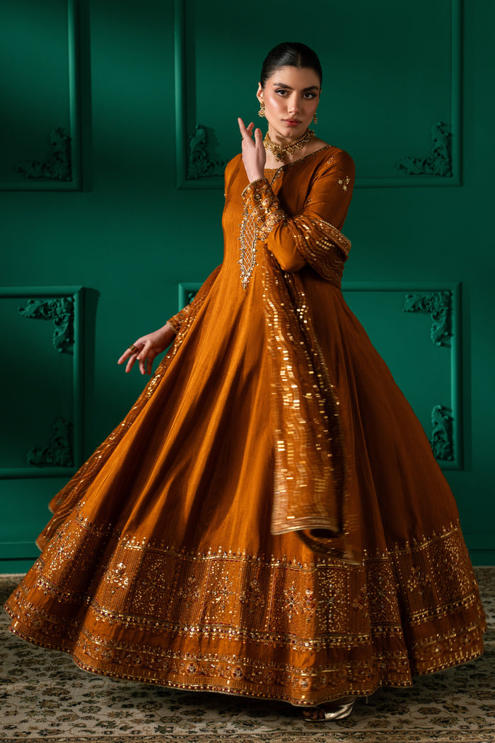 Full-length movement view of Nislihan highlighting the wide flowing panels, embroidered hem border and flared frock silhouette.