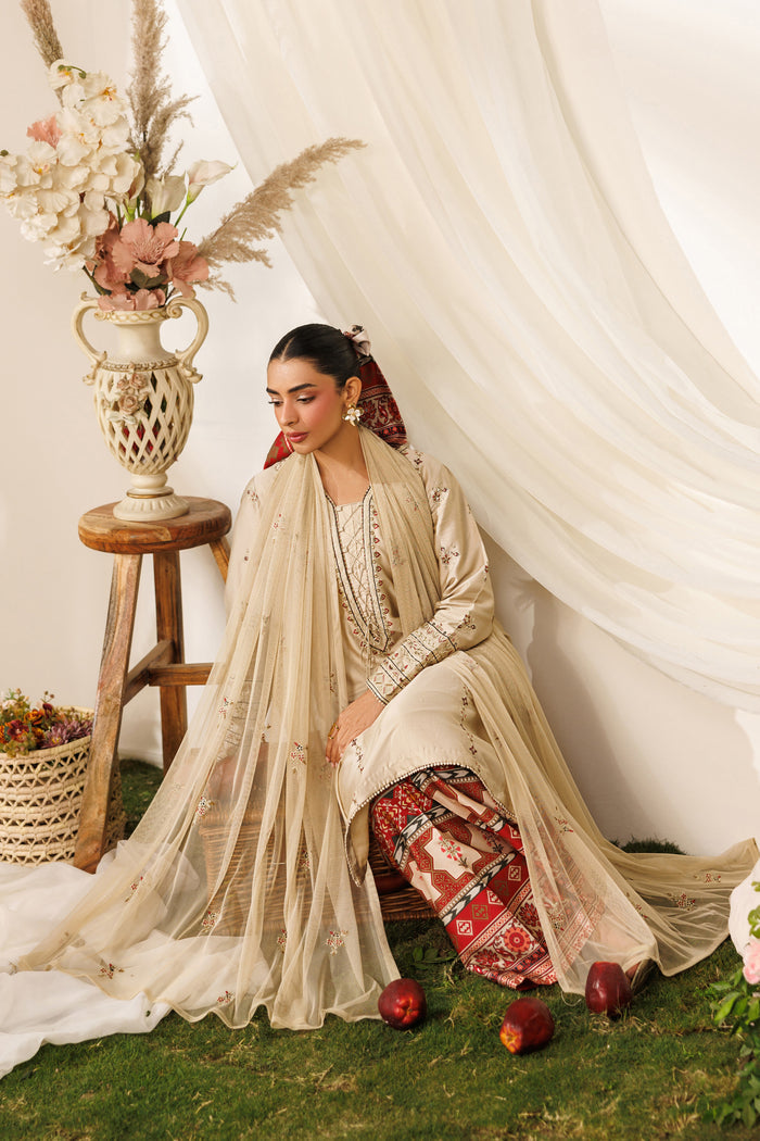 Seated pose of NAQSHI Numa outfit showing flowing net dupatta, printed culottes, and soft casual styling