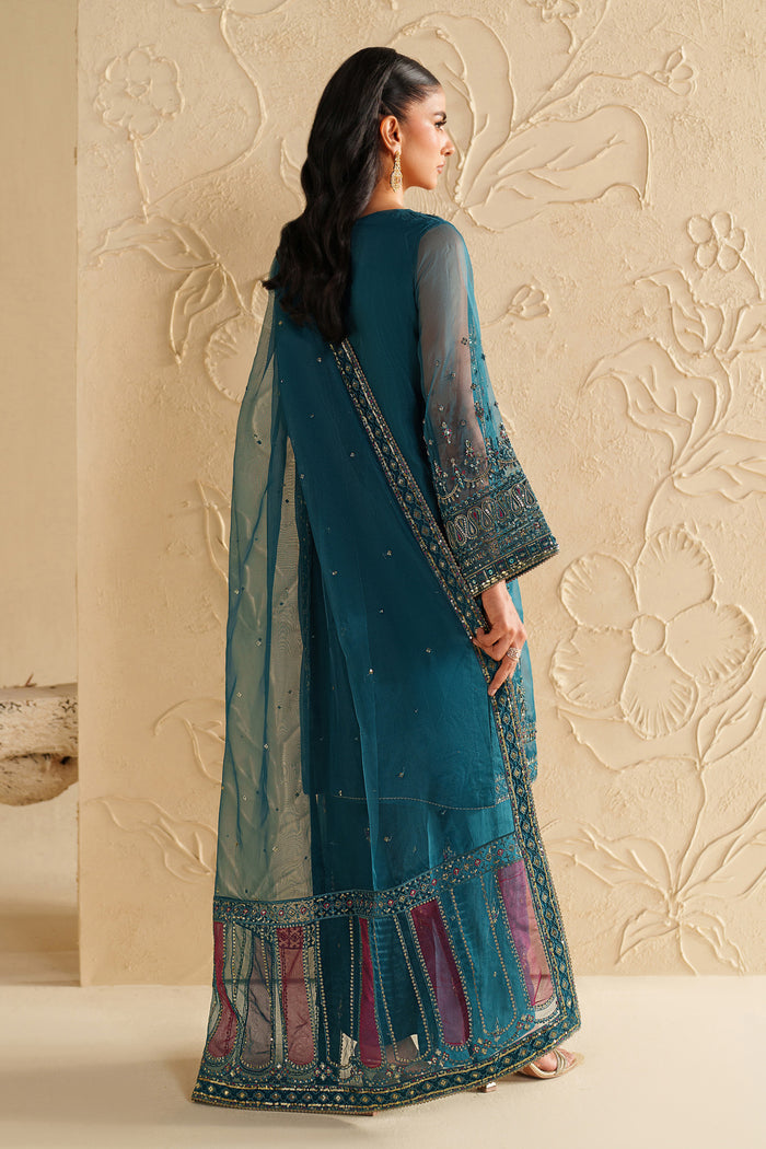 Back view of NAQSHI deep teal dress showing clean fall, embroidered borders, and graceful event styling