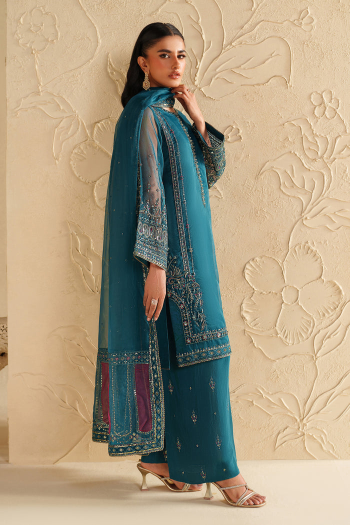 Side view of NAQSHI deep teal dress highlighting elegant shape, soft embroidery, and polished occasion look