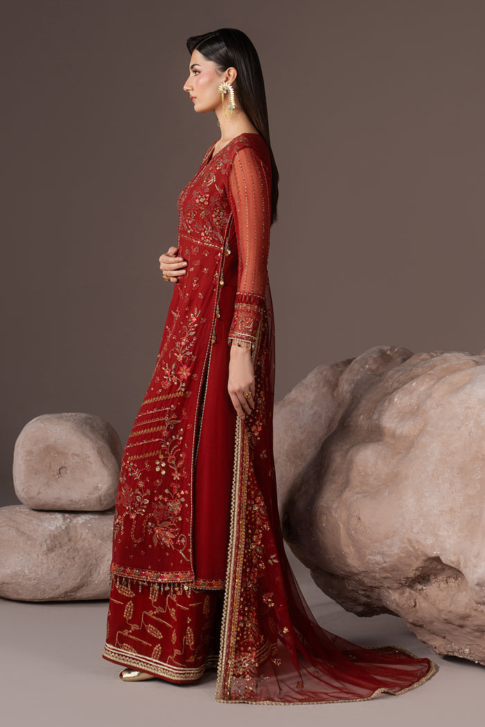 Side view of Rayaleen highlighting the rust orange A-line gown silhouette, flowing dupatta and PK Raw Silk flared pants.