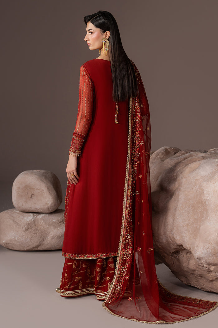 Back view of Rayaleen showing the long rust orange gown and embroidered Net dupatta with a soft flowing fall.