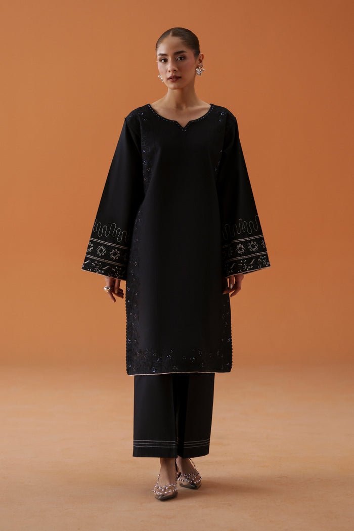Front look of Riedel black embroidered lawn shirt with cambric culotte trouser, designed as a light ready-to-wear semi-formal outfit.