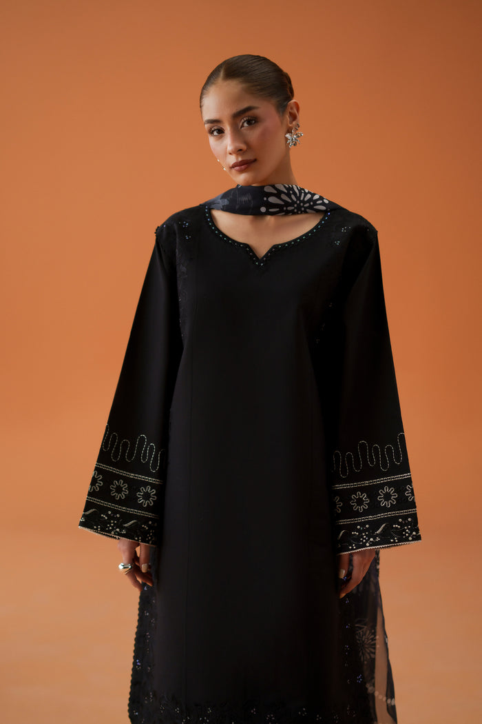 Close front view of Riedel black casual festive outfit showing neckline embroidery, loose sleeves, and clean ready-to-wear shirt design.