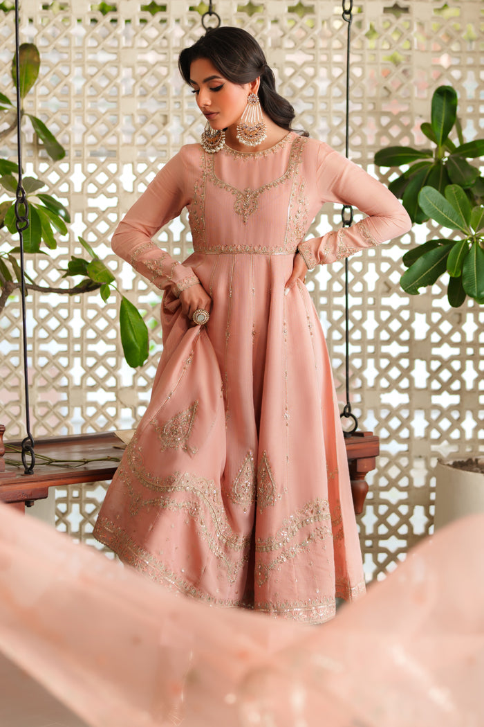 Model wearing complete NAQSHI Safron 3PC set: embroidered viscose frock, silk trouser & organza dupatta