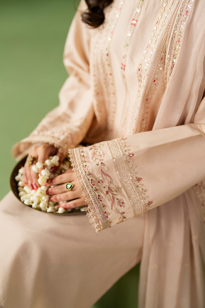 Close-up of NAQSHI Seema shirt sleeve showing embroidery detail and lace finishing