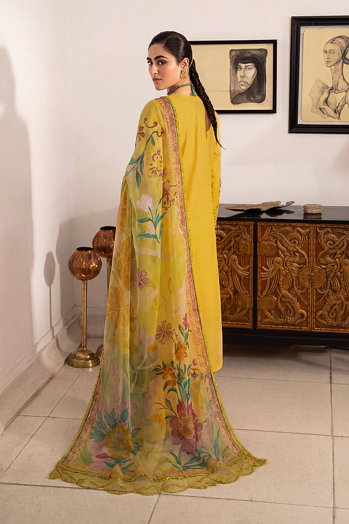 Side view of Seraya lemon embroidered lawn suit featuring floral embroidery, flared culottes and digitally printed tissue silk dupatta for summer occasions