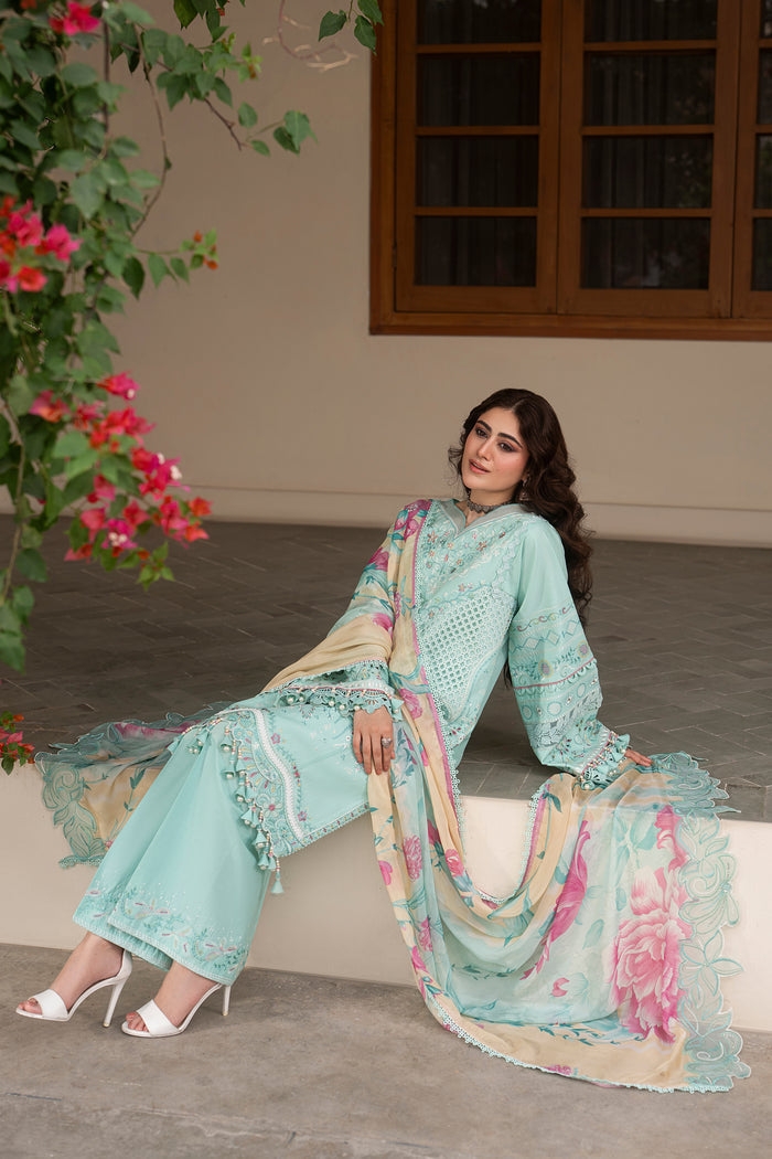 Seated pose of NAQSHI Shabeera aqua casual pret outfit showcasing embroidered shirt details, wide culotte trousers and flowing printed dupatta