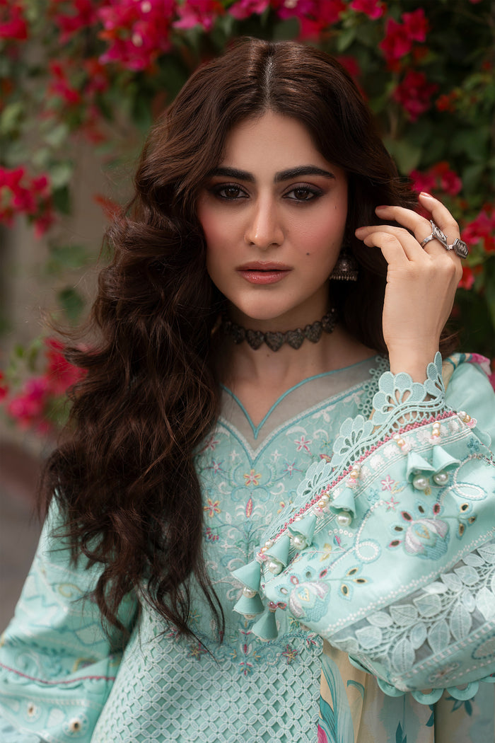 Close-up portrait of Shabeera aqua embroidered lawn dress highlighting embroidered neckline, organza detailing and delicate schiffli embroidery