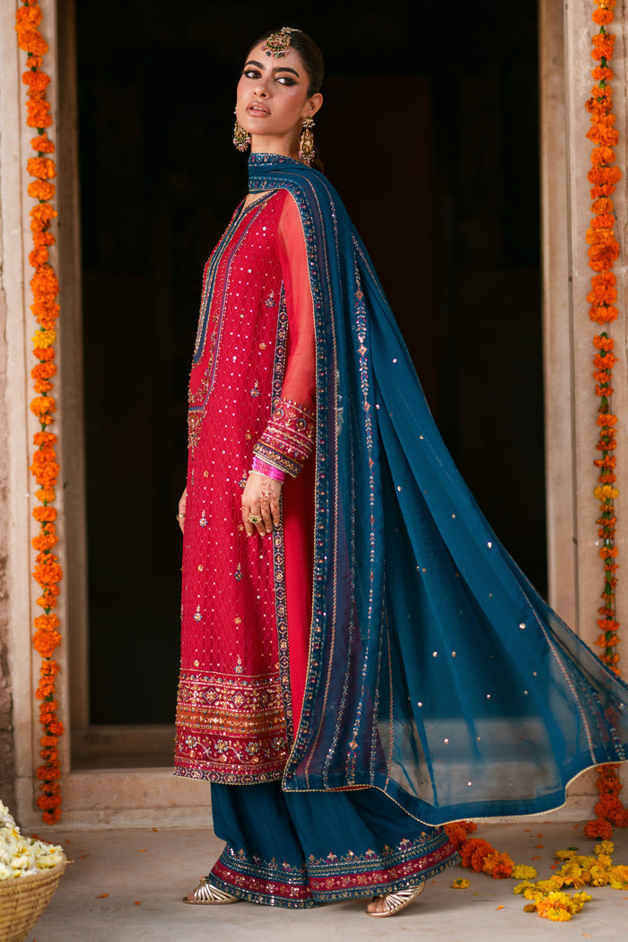 Side view of Shazim crinkle chiffon semi formal outfit featuring shocking pink shirt, zinc contrast dupatta and PK raw silk culotte trousers