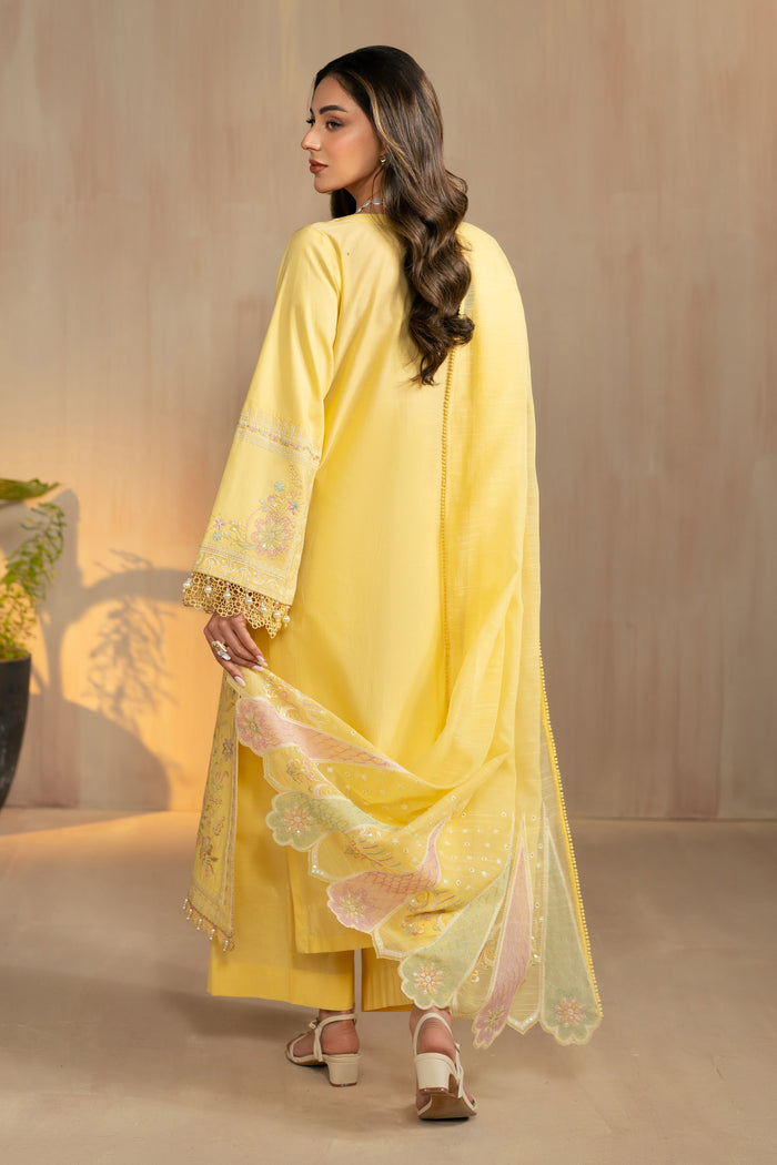 Walking side view of Sheiza yellow dress highlighting lightweight cotton organza dupatta and relaxed culotte trousers, breathable summer ready outfit.