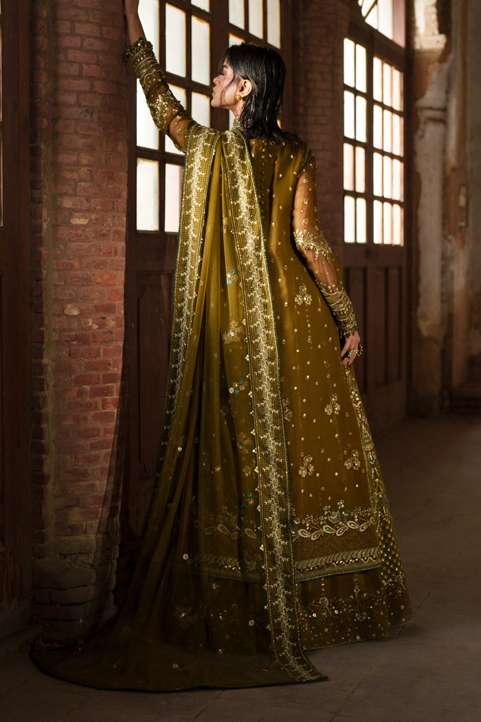 Sillage olive green gown back view showing fitted sleeves, embroidery and long flowing silhouette.