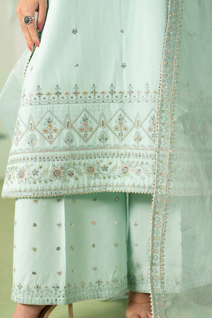 Detailed close up of heavily embroidered shirt border and trouser hem on Taabu aqua ready to wear suit