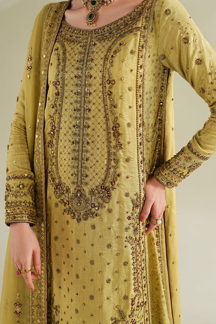 Close-up of golden formal shirt showing detailed front embroidery, neckline design, and fine fabric texture