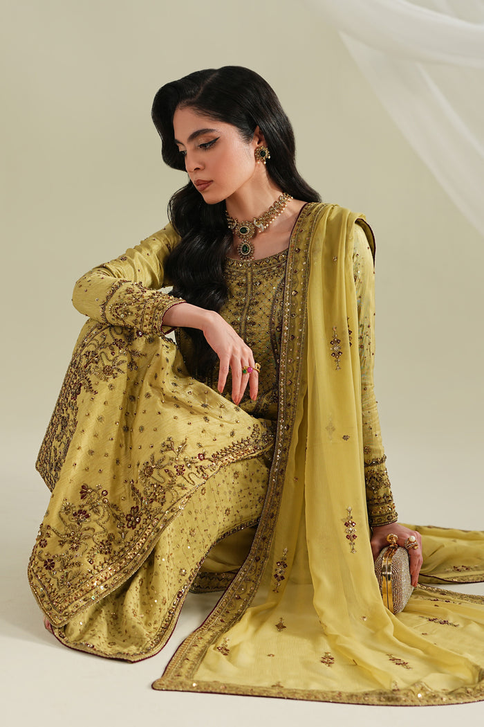 Golden formal ready-to-wear outfit with long shirt, culotte, and dupatta, seated pose showing elegant styling and fabric flow