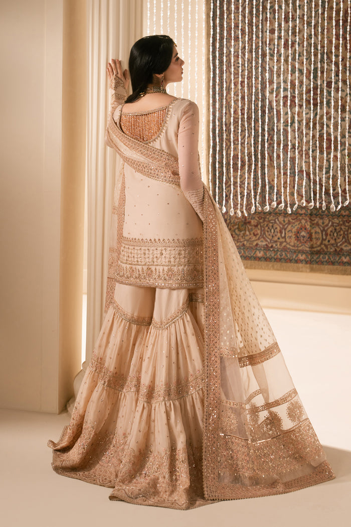 Back view of Tizmat peach organza Nikkah outfit with wide flare garara, neat stitching and soft sheer dupatta, modest and elegant ready to wear bridal formal dress.