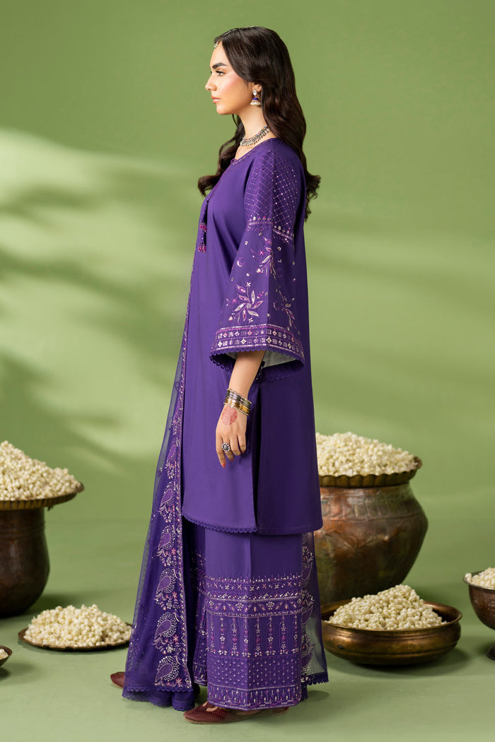 Side standing view of NAQSHI Uzma outfit showing straight lawn shirt cut and wide culotte trousers