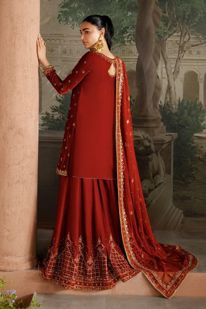 Side view of NAQSHI Vaneeza rust velvet sharara outfit showing full silhouette, detailed embroidery on shirt and flowing dupatta — ready-to-wear formal dress