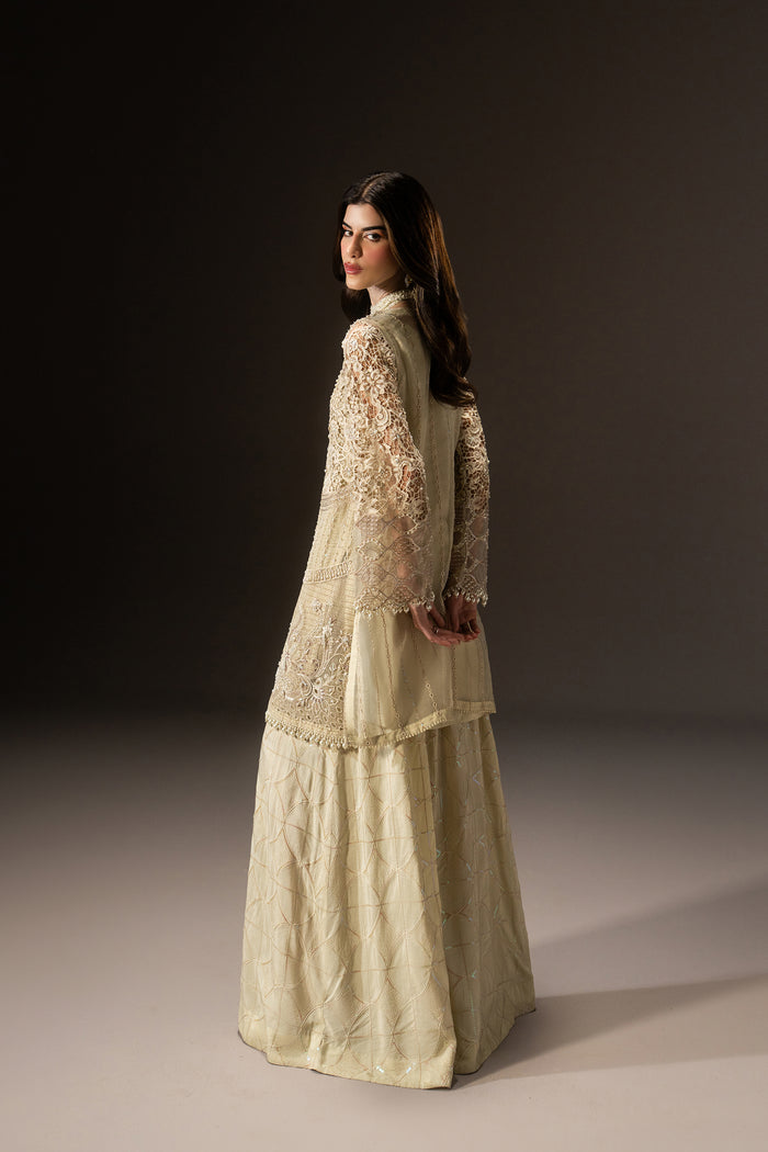 Side profile of Varena off-white 3-piece outfit highlighting the airy Organza shirt and full-length flared pants.