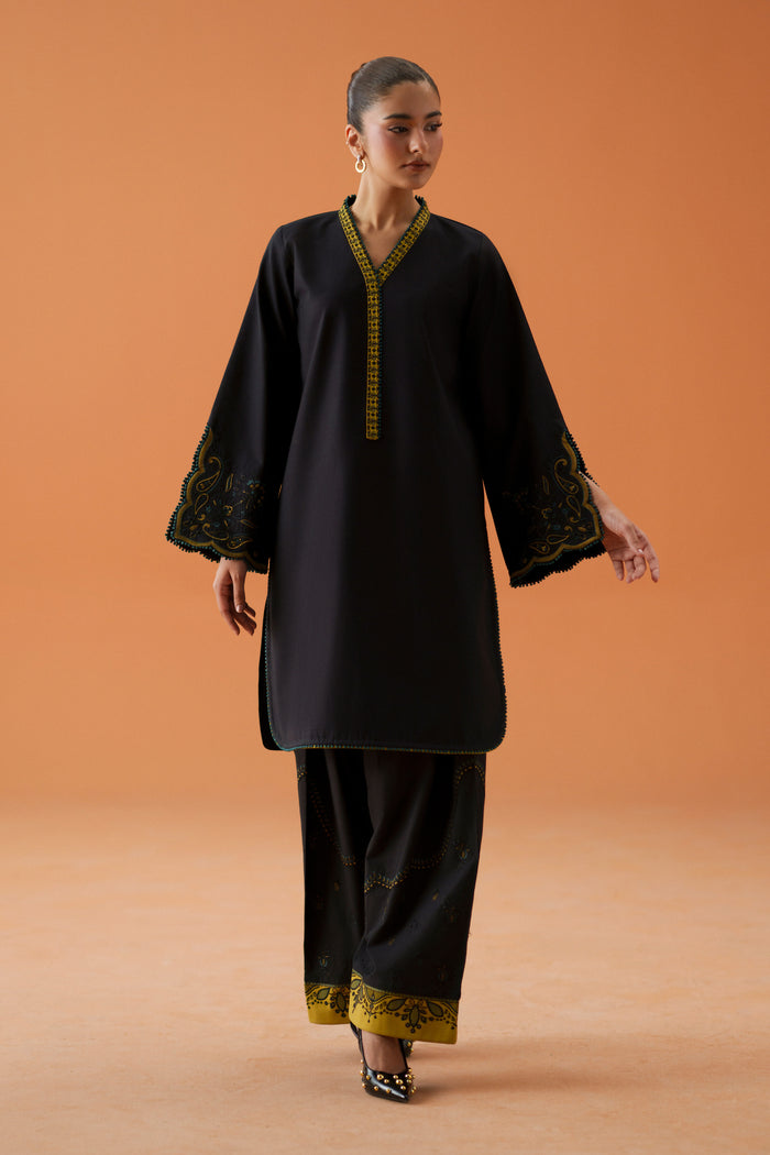 Front view of Vera black ready-to-wear dress showing loose embroidered shirt, cambric shalwar, and printed crinkle chiffon dupatta.