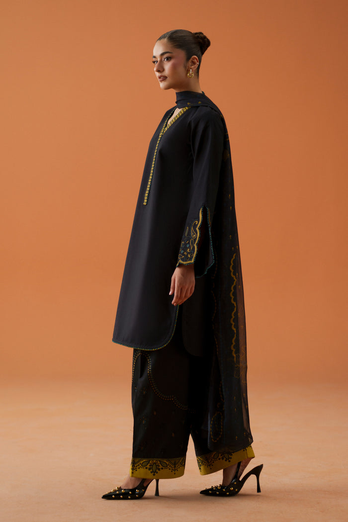 Side view of Vera black 3-piece outfit with relaxed lawn shirt, embroidered sleeves, printed chiffon dupatta, and cambric shalwar.