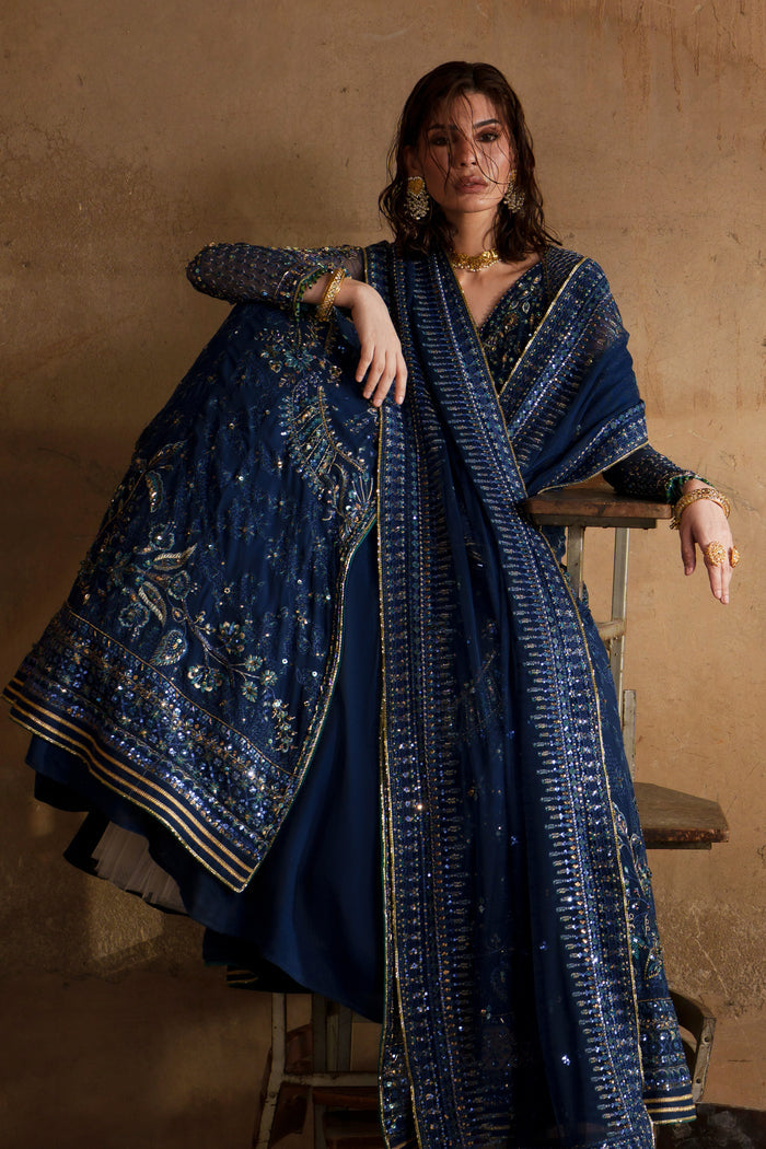 Viella blue formal outfit styled with detailed Net dupatta and flowing embroidered maxi.