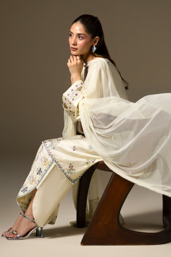 Willow Cream White outfit styled seated with embroidered Cotton Sateen culotte and flowing Net dupatta.