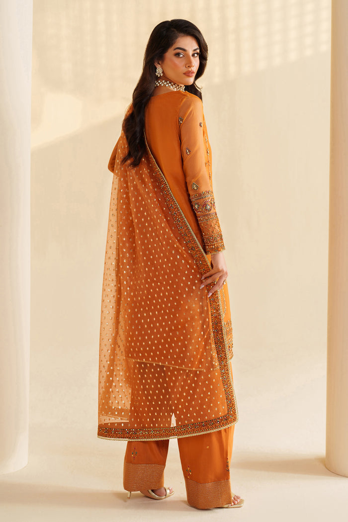 Back view of NAQSHI burnt orange formal ready-to-wear outfit showing straight fall, embroidered borders, and event-ready finish